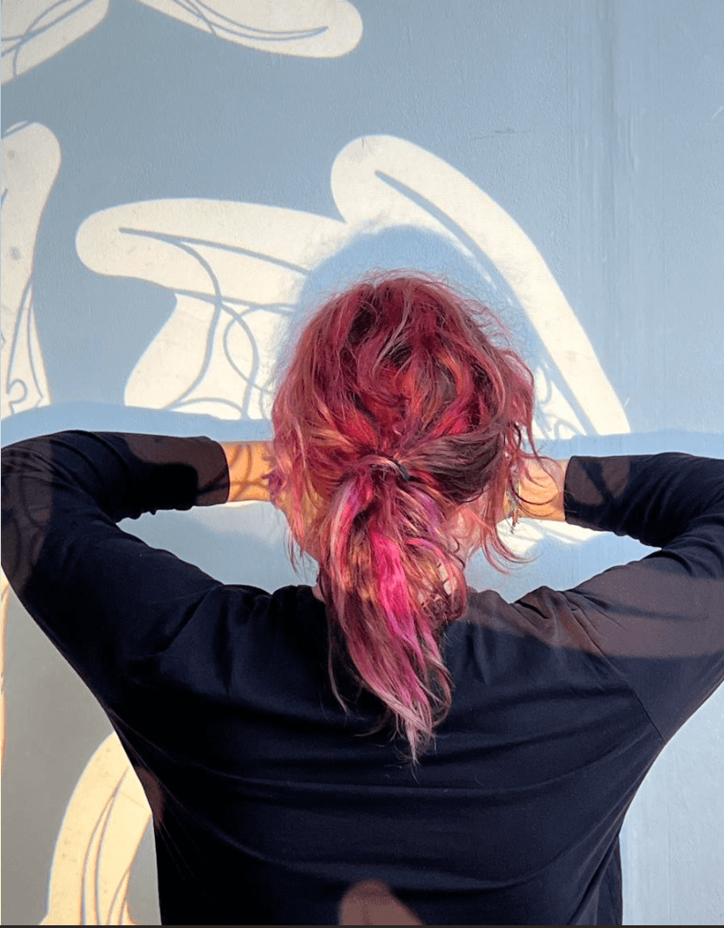 Back of a head with pink-streaked hair